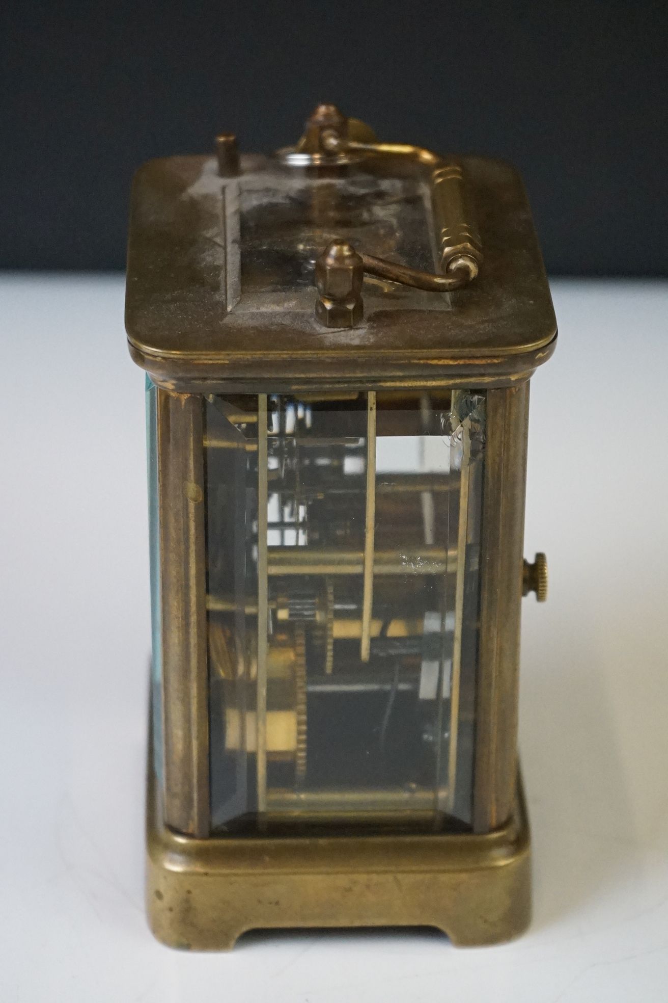 A brass cased carriage clock with beveled glass panels and white enamel dial, complete with key. - Image 3 of 15