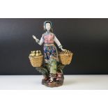 20th Century Chinese Famille Rose pottery figure of a lady with two baskets surmounted by chicks,
