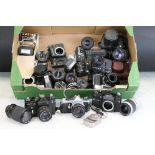 A collection of SLR film cameras with lenses and flashes to include Canon, Olympus, Zenit and Pentax