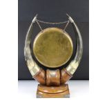 Edwardian Oak and Horn dinner gong, the central brass gong supported by two bovine horns mounted