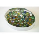 A small collection of vintage marbles of various sizes.