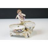 19th Century KPM Berlin Porcelain Table Salt in the form of a putti flanked by two bowls with hand