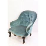 Victorian Button Back Armchair upholstered in blue fabric, raised on carved scrolling front legs