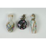 A collection of three miniature oriental glass scent bottle with hand painted decoration.
