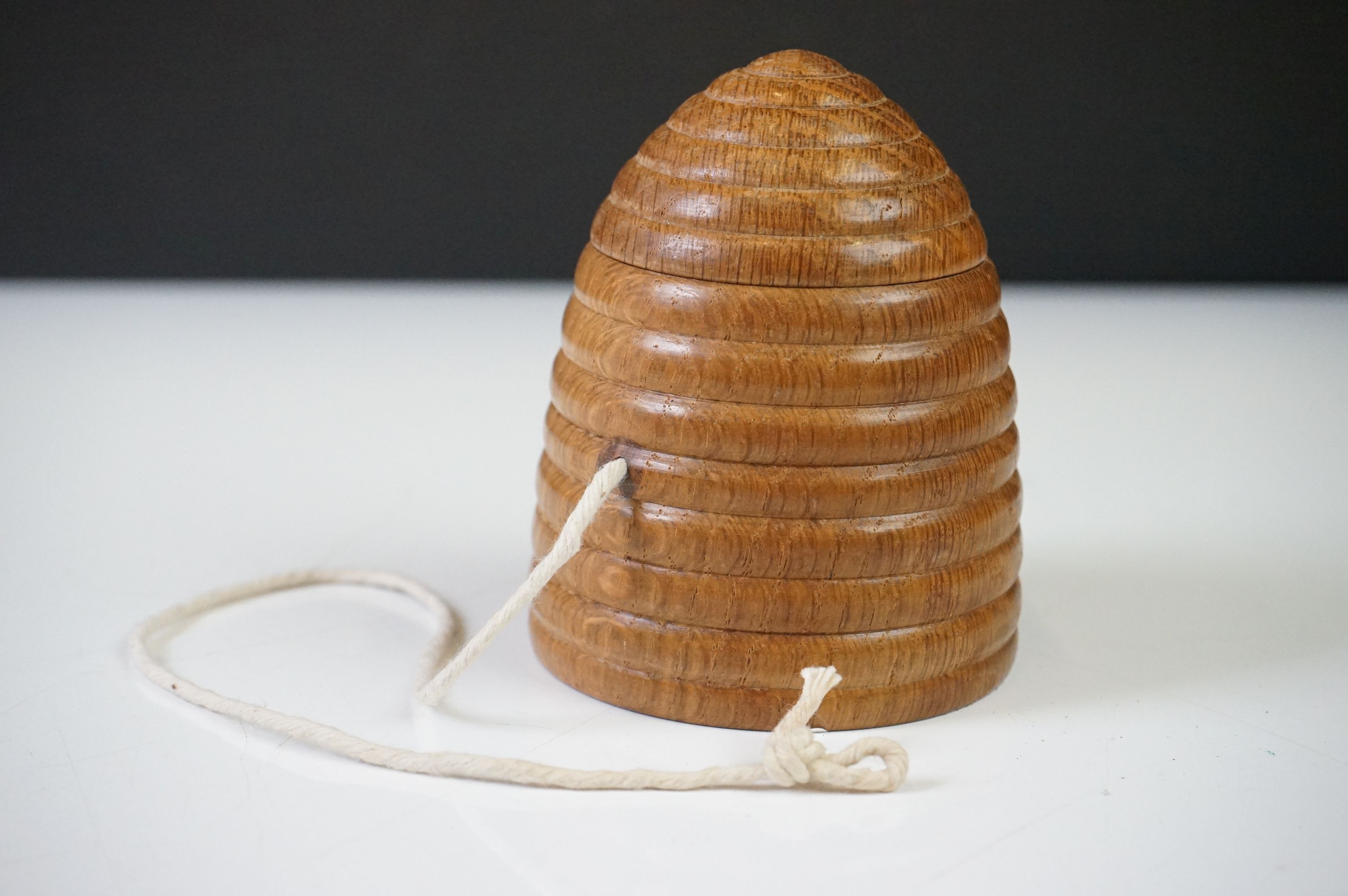 A vintage turned wooden string holder / dispenser in the form of a beehive.