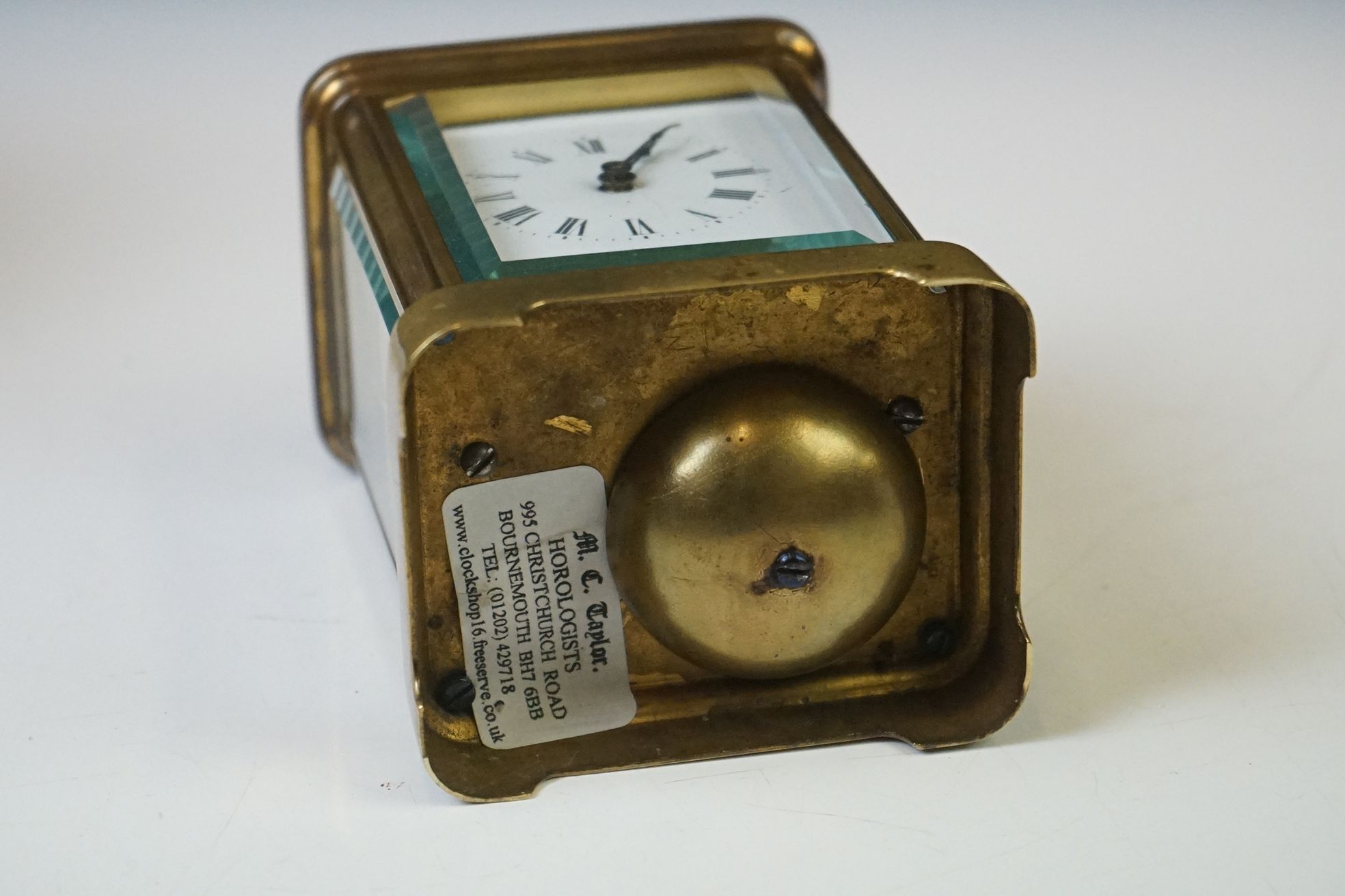 A brass cased carriage clock with beveled glass panels and white enamel dial, complete with key. - Image 14 of 15