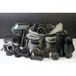 A Pentax SF1 35mm camera together with a collection of lenses and accessories.