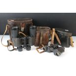 A collection of four pairs of vintage binoculars three with original leather cases.