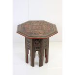 Burmese Red and Black Lacquered Octagonal Folding Table decorated with images of figures, birds,