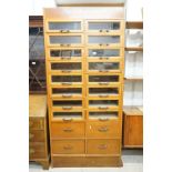 Early 20th century Shop Oak Haberdashery Cabinet with two banks of eight glass fronted drawers (16