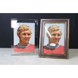 A signed Bobby Moore postcard mounted within a clear framed together with an unsigned example.