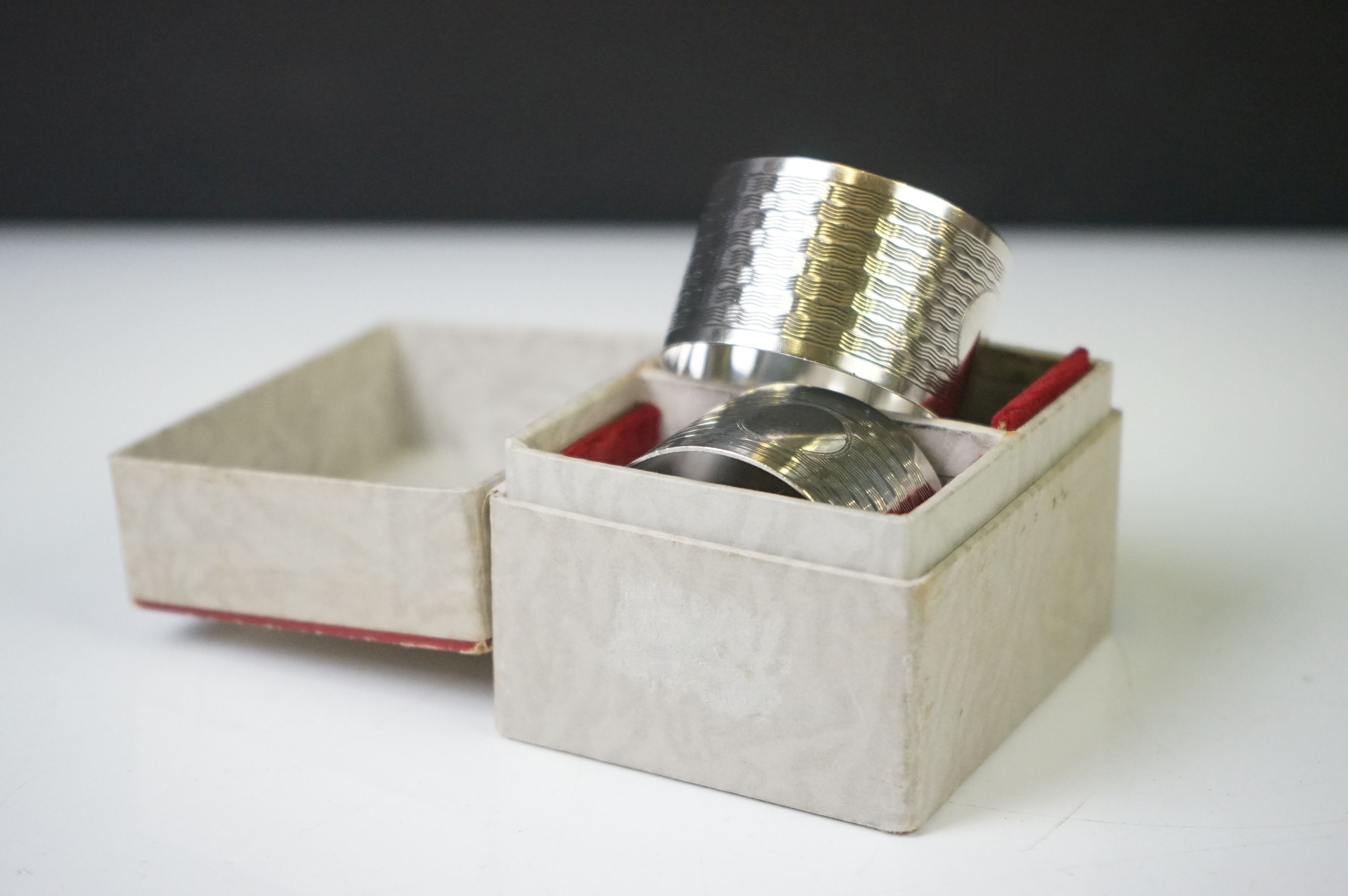 A pair of fully hallmarked sterling silver napkin rings with engine turned decoration and original