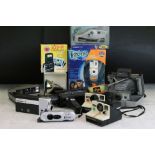 A collection of Polaroid cameras including a Polaroid SX-70 and two cine cameras including Canon.