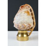 A hand carved cameo shell converted into a table lamp.