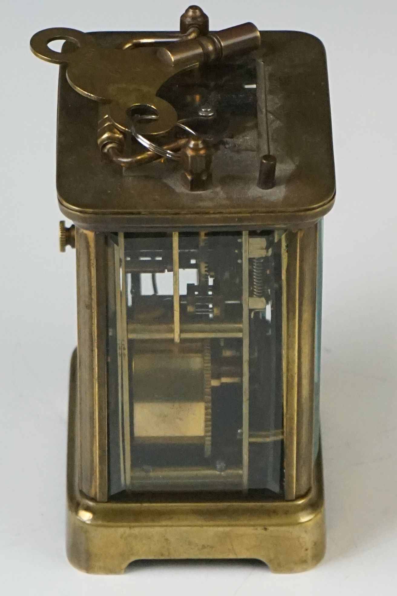 A brass cased carriage clock with beveled glass panels and white enamel dial, complete with key. - Image 11 of 15