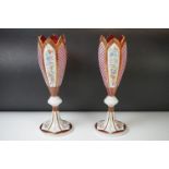 Pair of 19th Century Bohemian Cranberry Glass Fluted Vases, with lozenge shaped enamelled panels