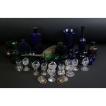 Collection of 27 glass eye baths, mostly 20th century, to include Bristol blue, green and clear