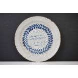 18th Century English Delft tin glazed plate, with 'who uses me with diligence, 1712' text and leaf