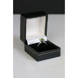 A 925 sterling silver ring set with green centre stone.