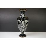 Late 19th Century Black Urn-shaped Glass Vase enamelled with butterflies amongst leafy branches,