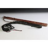 Plaited Black leather bullwhip with wrist strap, together with a 20th century turned wooden