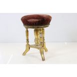 19th century Giltwood Circular Adjustable Piano Stool raised on three turned legs, 37cm diameter