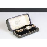 An antique 14k gold cased Benrus ladies cocktail watch complete with display case.