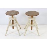 Pair of Circular Adjustable Stools with part cream painted distressed finish