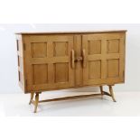 Ercol Blonde Elm Sideboard, model 120, the two doors opening to two drawers and a shelf, 122cm