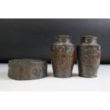 Pair of Japanese metal storage jars & covers relief decorated with dragons and birds, with inner