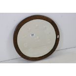 Early 20th century Circular Oak Framed Mirror, the plate with bevelled edge and eleven internal