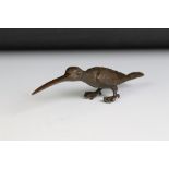 An oriental miniature bronze figure in the form of a bird, character marks to underside.
