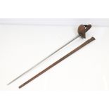 A Cavalry troopers sword complete with metal scabbard, the blade marked 'Wilkinson'.