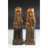 Pair of Carved Wooden Figures of Bearded Men carrying metal staffs, 35cm high