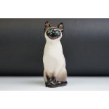 Winstanley pottery figure of a seated Siamese cat, with blue glass eyes, numbered 34, signed '