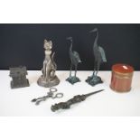 A box of mixed collectables to include a cast iron devil winged dagger, a pair of oriental storks,