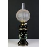 A Hinks oil lamp with glass and enamelled base, complete with glass globe and chimney.