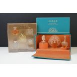 Two boxed sets of Lalique collection miniature scent bottles.