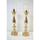 A pair of large brass lamp bases, stand approx 51cm in height.