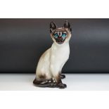 Winstanley pottery model of a Seated Siamese Cat, with blue glass eyes, marked ' Kensington 32