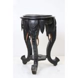 Ebonised Circular Jardiniere / Plant Stand, the supports carved in the form of elephant heads,