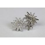 Pair of silver and CZ sunburst style stud earrings