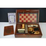 An early 20th century wooden cased games compendium to include Solitaire, Cribbage, Chess....etc.