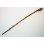 A vintage hand carved walking stick with figural head handle.