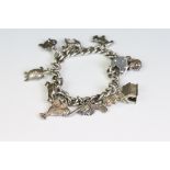 A white medal chain link charm bracelet complete with charms.