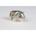 Silver guinea pig figure with ruby eyes