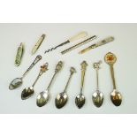 A small collection of commemorative souvenir spoons together with a hallmarked silver and mother