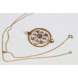 A early 20th century art nouveau 9ct gold pendant and necklace decorated with seed pearl and