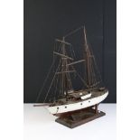 A vintage kit built twin mast wooden ship on stand.