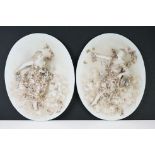 Pair of Early 20th century Oval Bisque Plaques with relief decoration of two ladies holding